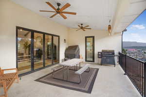Balcony off of main living area featuring ceiling fan, grilling area, and a mountain view
