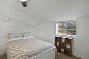 Bedroom off hall featuring a ceiling fan and carpet