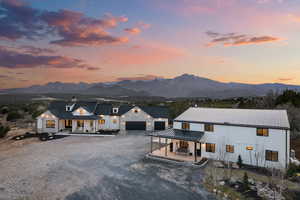 Modern farmhouse with gravel driveway,and barndominium