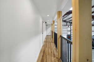 Hall upstairs in basketball court in the barndominium. It has 3 bedrooms off of this and a full bathroom