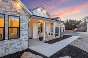 View of exterior entry with stone siding,