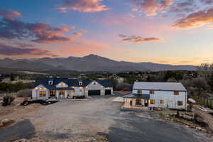 View of front of property with driveway, main home and barndominium