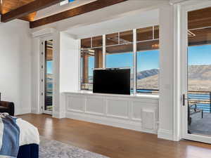 Living room with wood-type flooring, lofted ceiling with beams, and wood ceiling