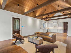 Living area featuring a high wooden beamed ceiling and hardwood / wood-style flooring
