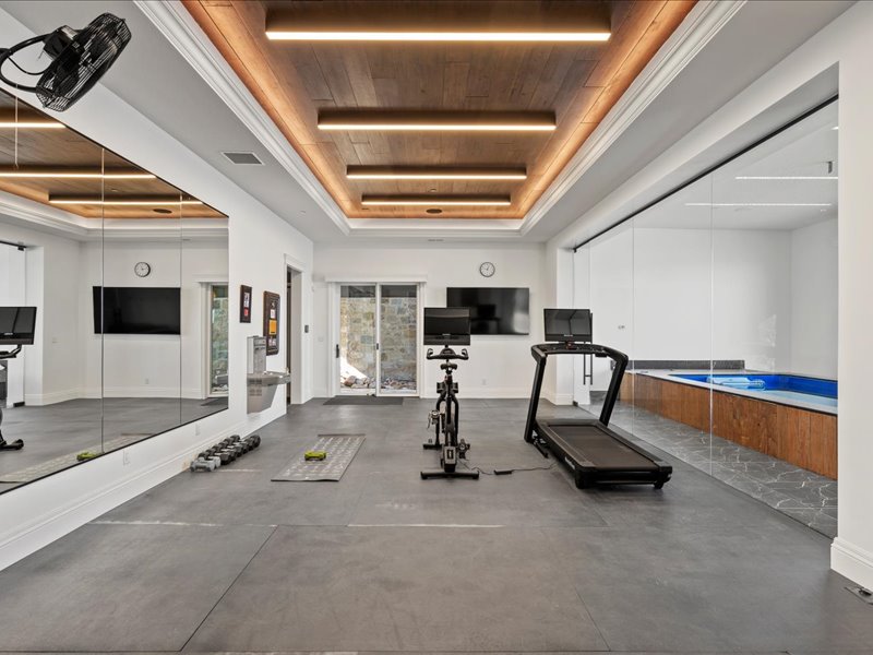 Workout area featuring a wooden tray ceiling