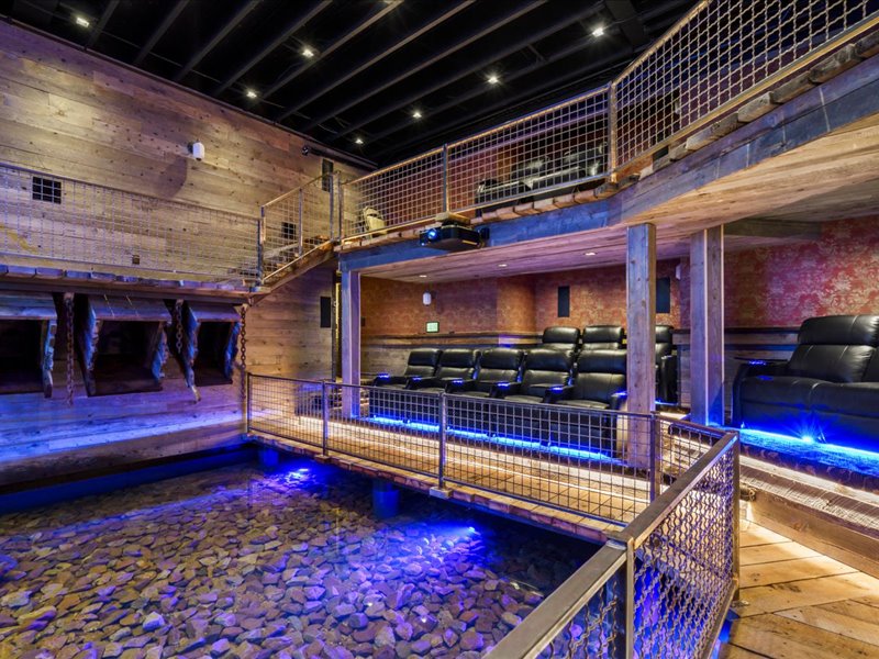 Rec room featuring a high ceiling and wooden walls