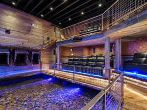 Rec room featuring a high ceiling and wooden walls