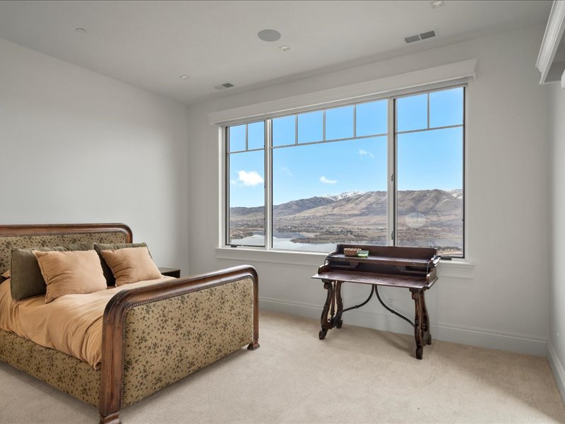 Bedroom featuring a mountain view and light colored carpet