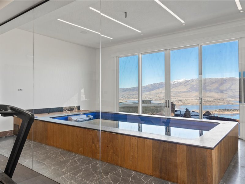 Kitchen featuring modern cabinets, wood finish cabinetry, a mountain view, and light stone countertops