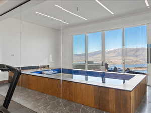Kitchen featuring modern cabinets, wood finish cabinetry, a mountain view, and light stone countertops