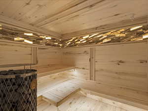 Relaxing sauna / steam room featuring wooden ceiling and wood walls