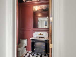Half bathroom with vanity and tile patterned floors