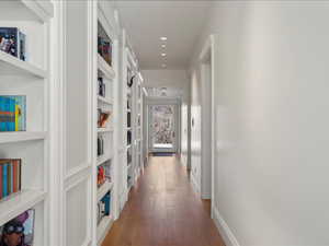 Corridor with wood-type flooring and recessed lighting
