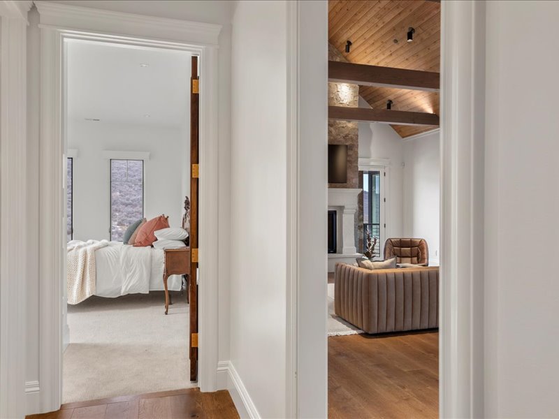 Hall with vaulted ceiling with beams, wooden ceiling, and wood finished floors