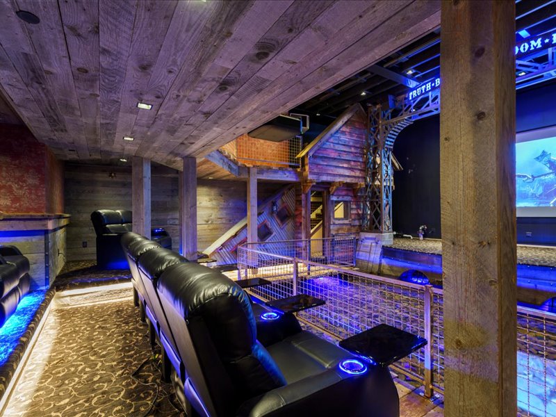 Home theater with wood ceiling and wood walls