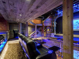 Home theater with wood ceiling and wood walls