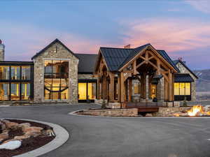 View of building exterior featuring an outdoor fire pit