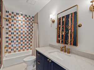 Full bathroom with vanity and shower / bath combo with shower curtain