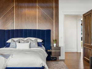 Bedroom featuring hardwood / wood-style flooring and baseboards