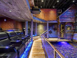 Home theater featuring hardwood / wood-style flooring and a high ceiling
