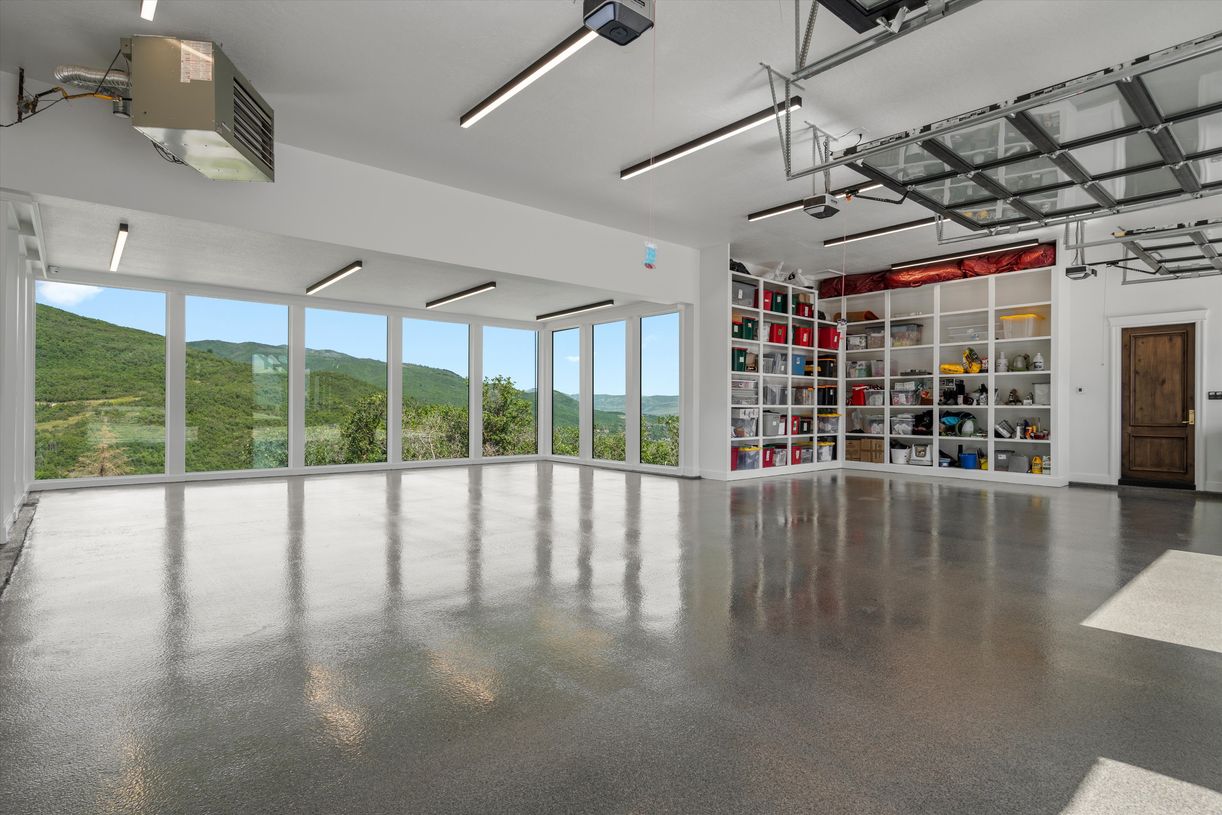 Spacious garage with polished concrete flooring and extensive built-in shelving
