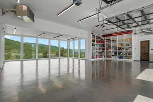 Spacious garage with polished concrete flooring and extensive built-in shelving