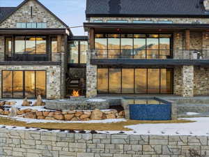 Rear view of property with a balcony and a patio area
