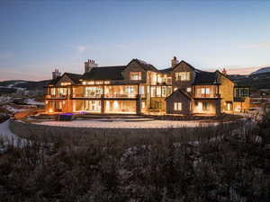 Rear view of property with a balcony, a chimney, and an outdoor pool