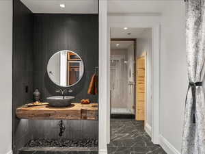 Full bathroom with a stall shower, dark marble finish floors, vanity, and recessed lighting