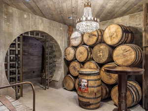 Wine room with a chandelier and concrete flooring