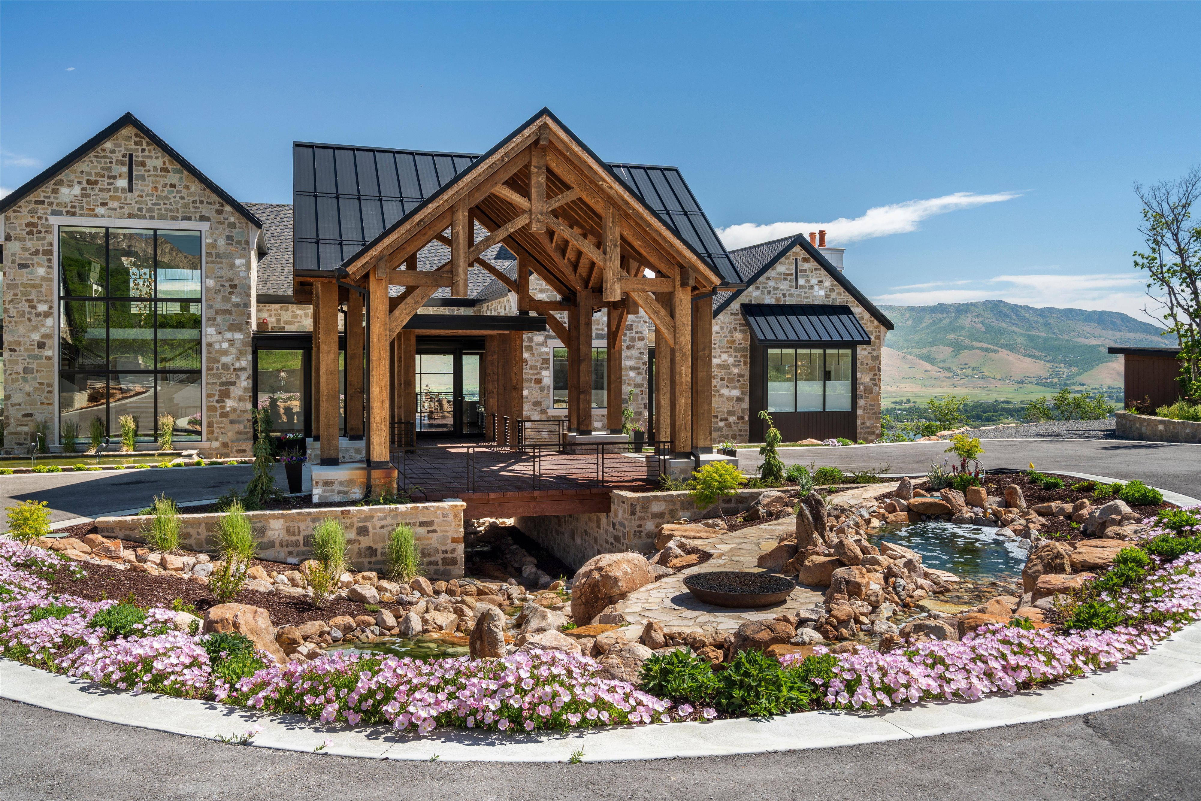 Stone facade residence featuring a prominent timber-frame portico