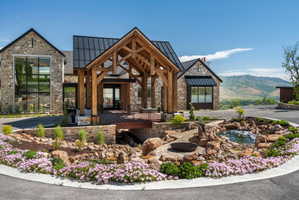 Stone facade residence featuring a prominent timber-frame portico