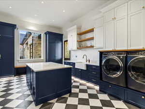 Laundry area featuring light flooring, separate washer and dryer, recessed lighting, and cabinet space