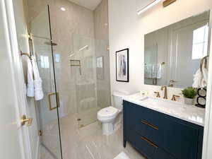 Bathroom with vanity, a shower stall, and light tile patterned floors