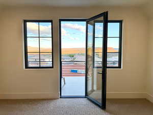 Doorway to outside with carpet flooring