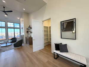 Sitting room with ceiling fan, light wood-type flooring, recessed lighting, and vaulted ceiling