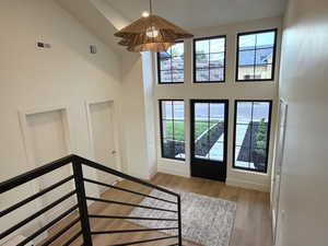 Entrance foyer featuring a high ceiling, light wood-type flooring, and recessed lighting