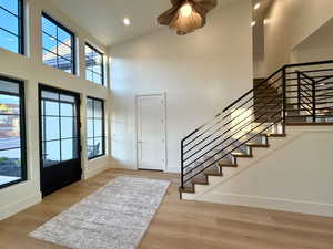 Entrance foyer with light wood-type flooring, recessed lighting, and lofted ceiling