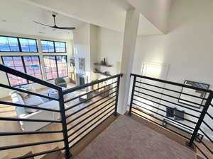 Stairs featuring a high ceiling and ceiling fan