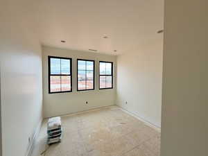 Spare room featuring baseboards