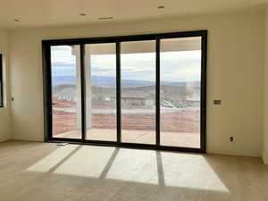 Empty room with light wood-style floors and a mountain view
