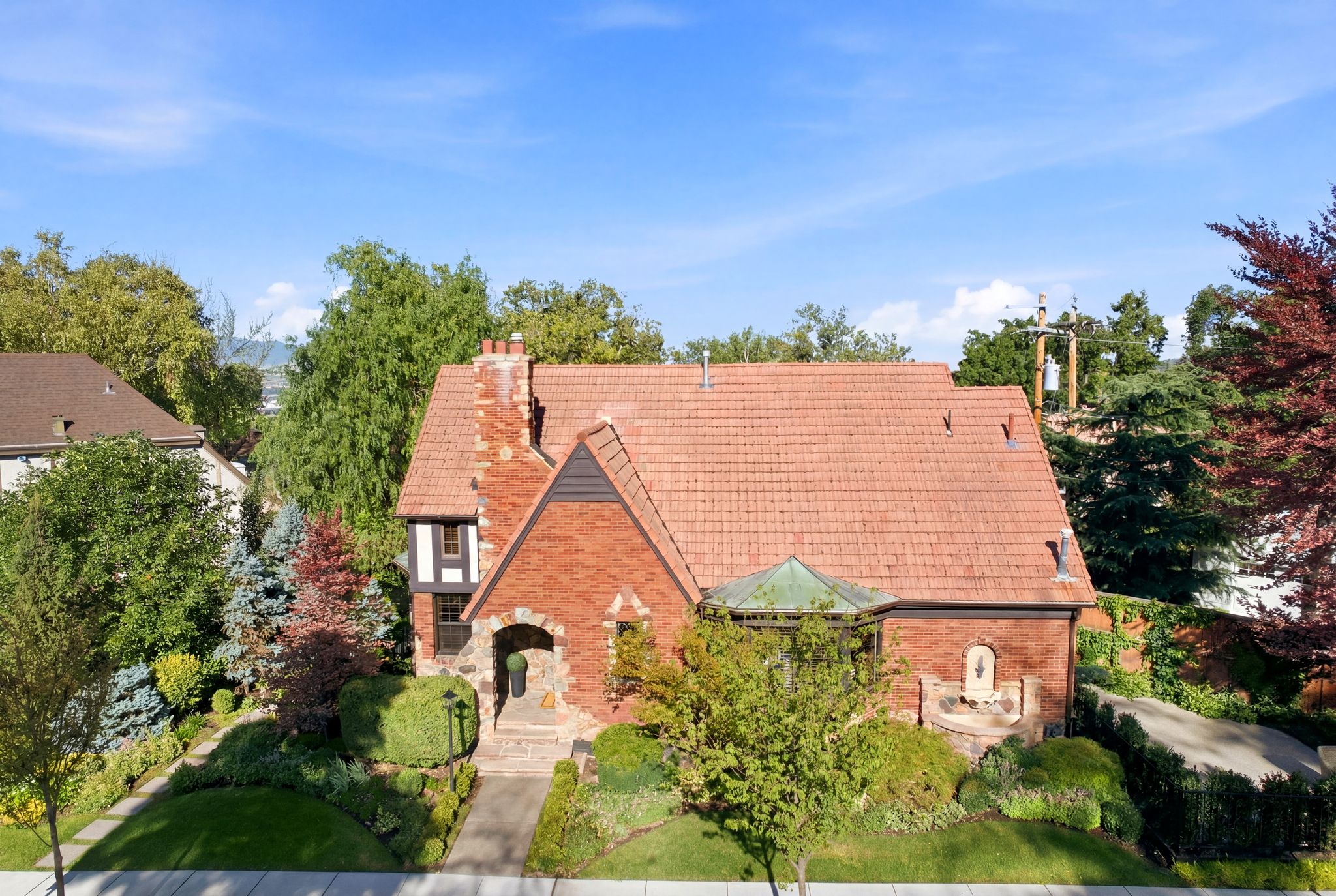 Brick and stone exterior with a red tile roof