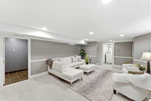 Carpeted living area featuring recessed lighting and washer / dryer