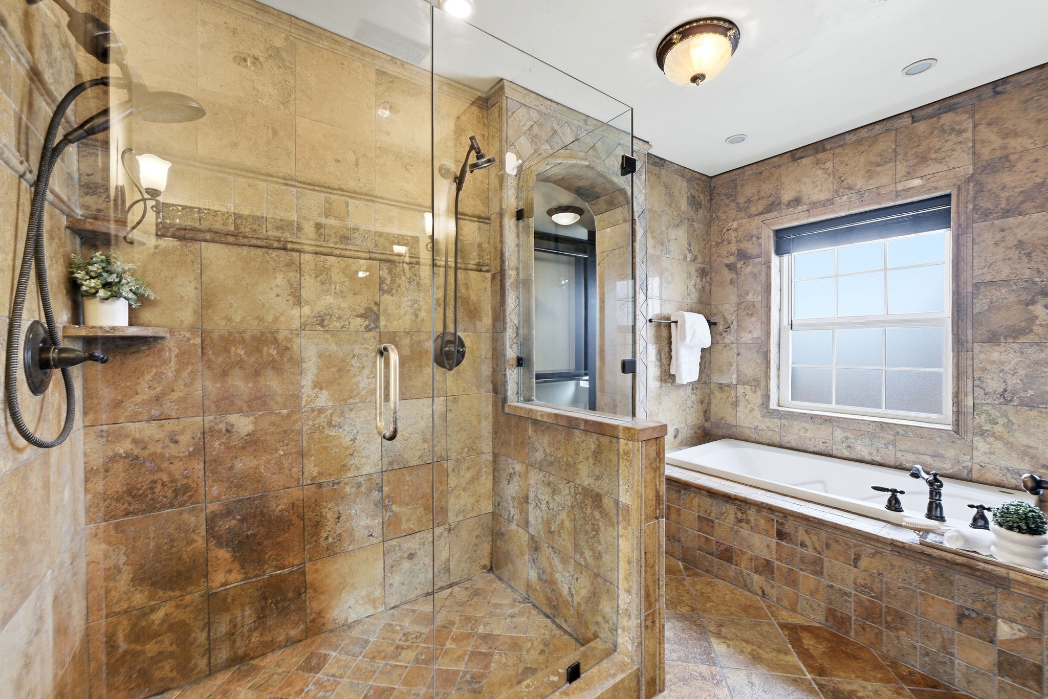 Full bathroom featuring a garden tub and a shower stall