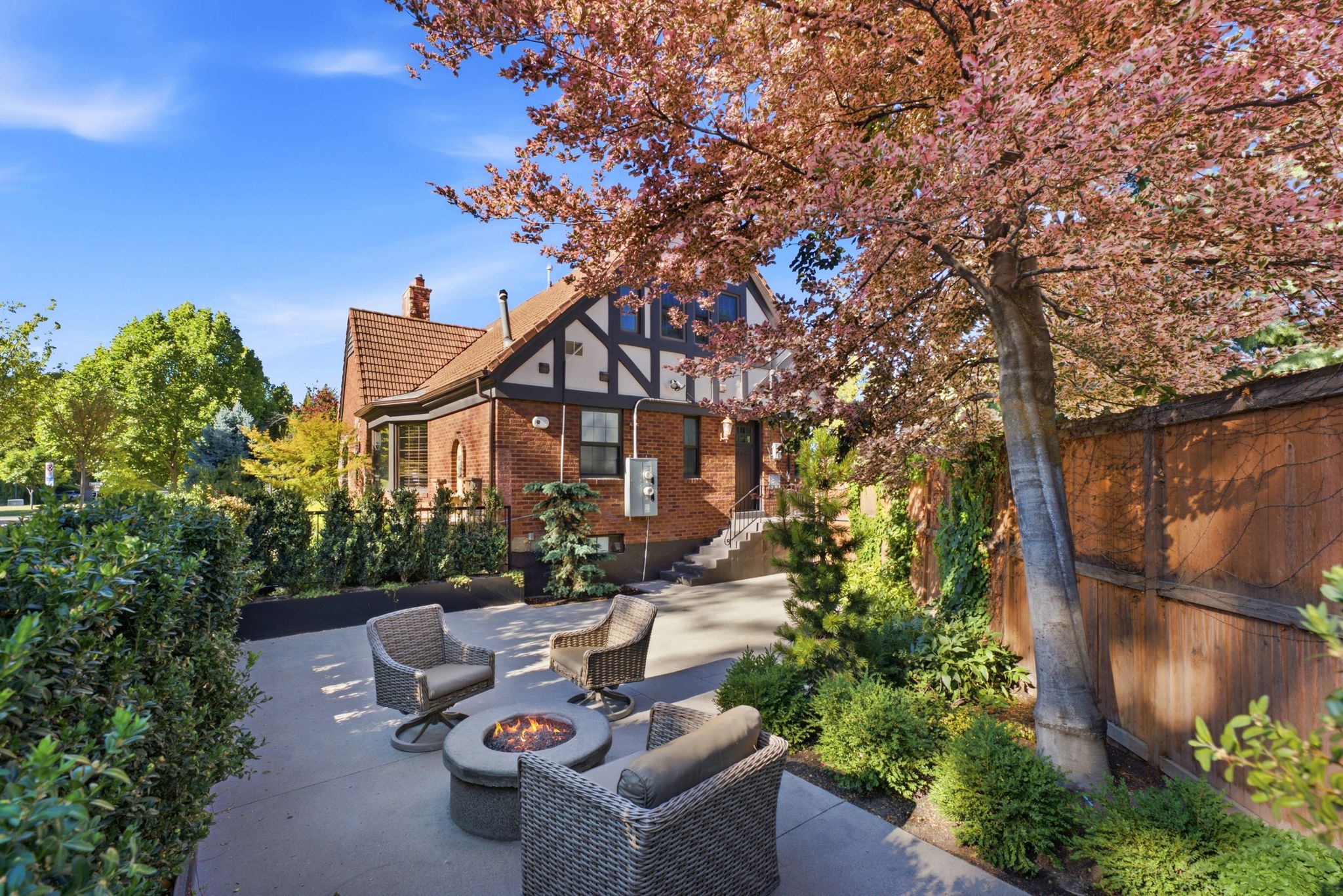 Brick Tudor-style residence featuring a terracotta-tiled roof and decorative half-timbering