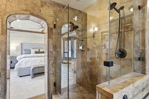 Full bathroom with a shower stall and connected bathroom