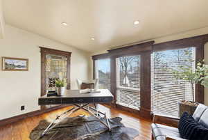 Office featuring wood-type flooring, vaulted ceiling, and recessed lighting