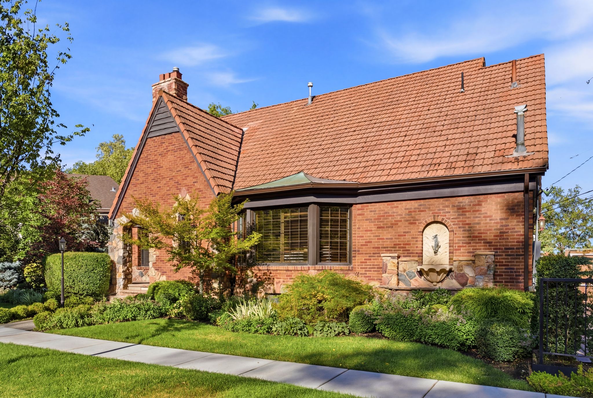 Brick exterior with a red tile roof and bay window