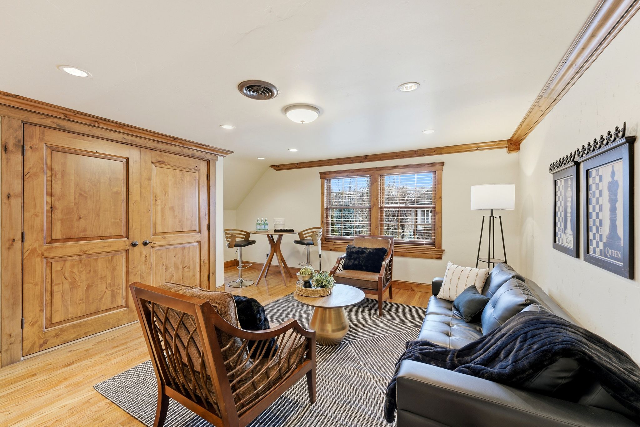 Living area with wood finished floors, lofted ceiling, recessed lighting, and ornamental molding