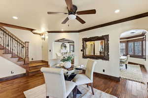 Dining room featuring ceiling fan, hardwood / wood-style floors, crown molding, arched walkways, and recessed lighting